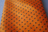 orange tie with black polka dots